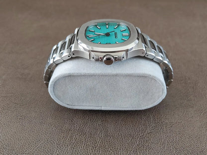 Luxury watch with Tiffany green dial, silver stainless steel case and bracelet, round 40mm face.