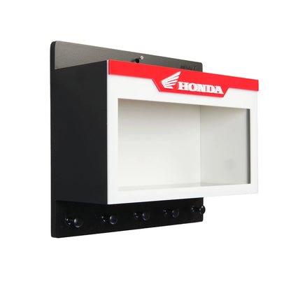 Black and white wall key hook rack with red Honda logo and scale model display case.