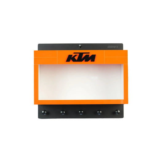 Orange and black KTM wall-mounted key hook rack with four metal hooks and a display shelf above the hooks.
