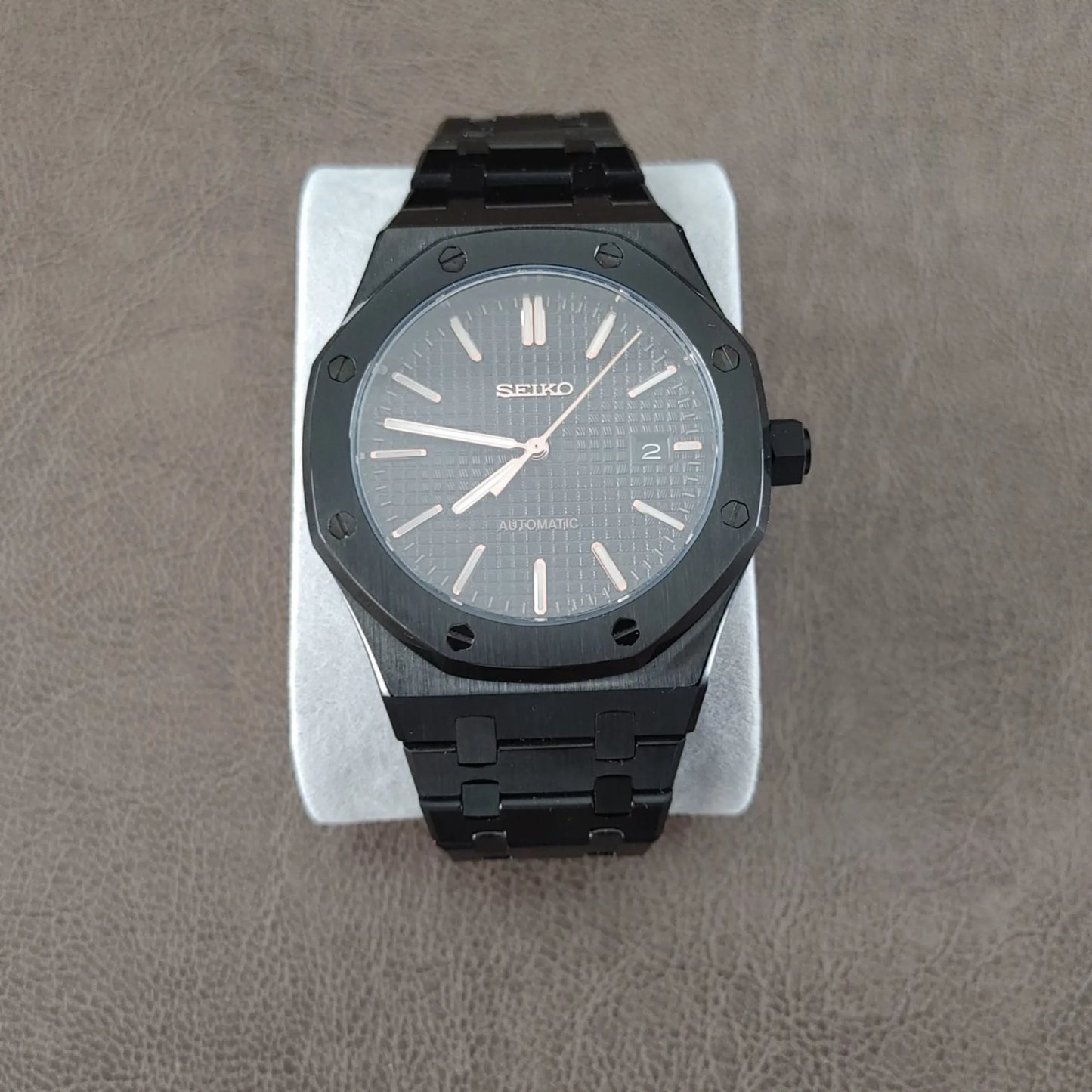 Black and rose gold Seiko Royal Oak 41mm watch with textured dial and black metal bracelet.