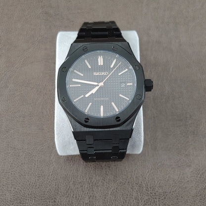 Black and rose gold Seiko Royal Oak 41mm watch with textured dial and black metal bracelet.