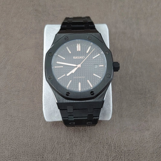 Black and rose gold Seiko Royal Oak 41mm watch with textured dial and black metal bracelet.