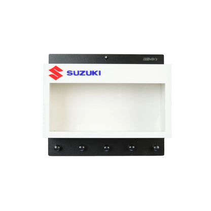 White and black Suzuki wall key hook rack with Scale Model Motorcycle Display Case and five black hooks.
