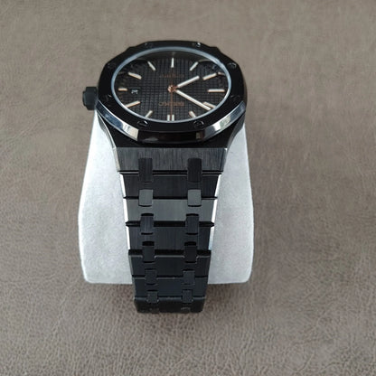 41mm black royal oak style watch with rose gold hands and hour markers, black metal bracelet.