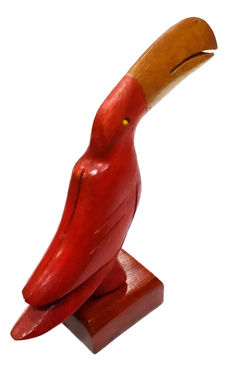 Handcrafted wooden toucan sculpture in red and brown Brazilwood with curved beak on a rectangular base.