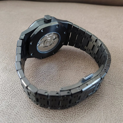 Black and silver 41mm Seiko Royal Oak watch with stainless steel bracelet and transparent case back showcasing the movement.