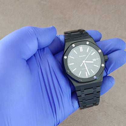 Black and silver Seiko NH35 Royal Oak style watch with octagonal bezel and metal bracelet.