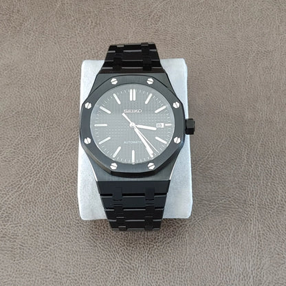 Black stainless steel Royal Oak style watch with silver hour markers and hands, 41mm round case with hexagonal screws.