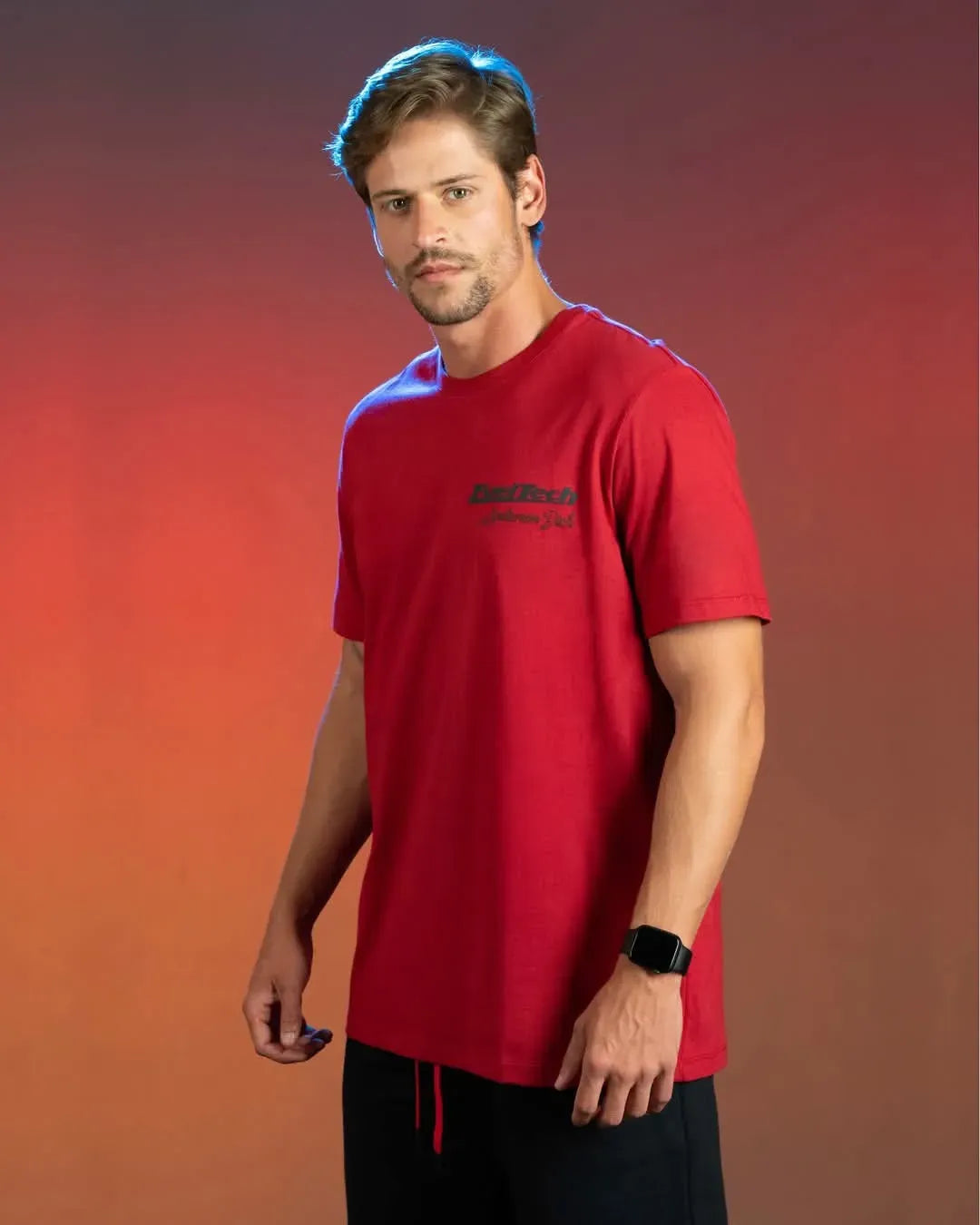 Red short-sleeve crewneck t-shirt with small black logo on left chest, worn by male model.