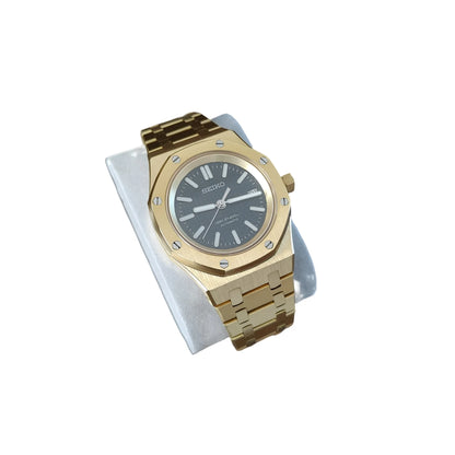 41mm gold-tone watch with black dial, gold hour markers, and linked bracelet on white cushion.