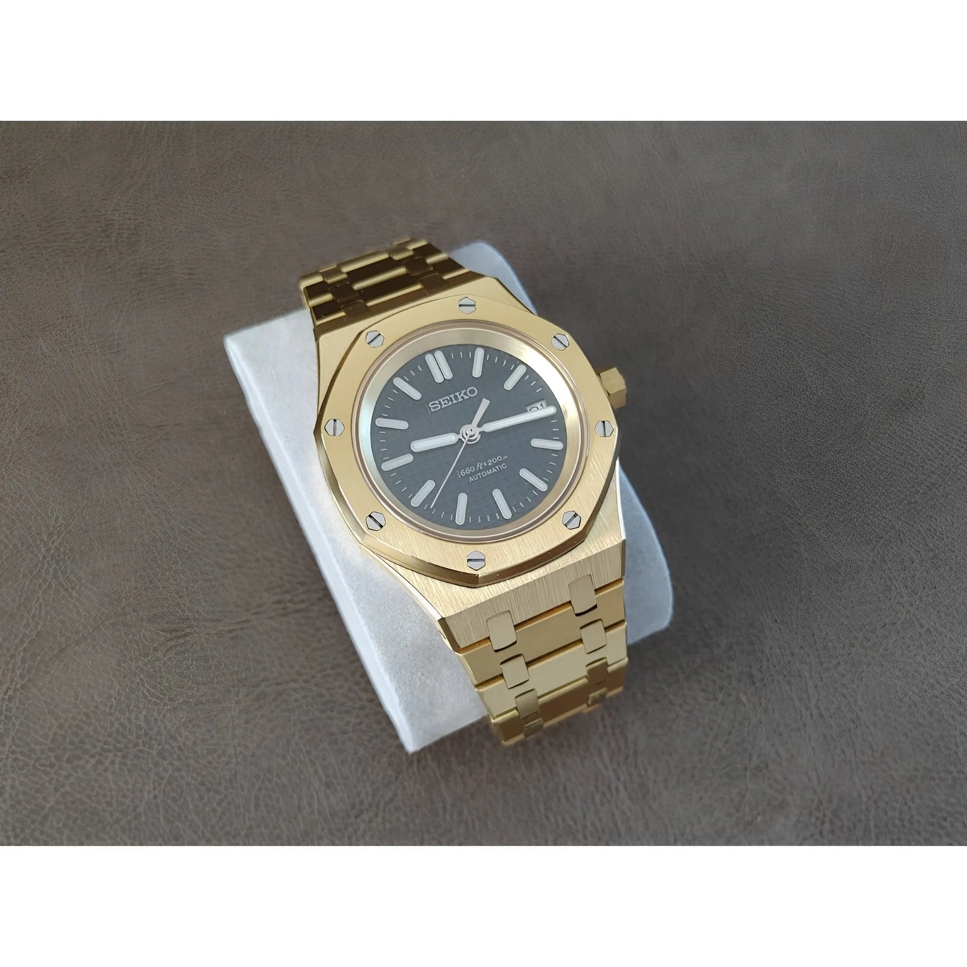 Seiko NH35 Royal Oak style gold-tone stainless steel watch with black dial and gold hour markers.
