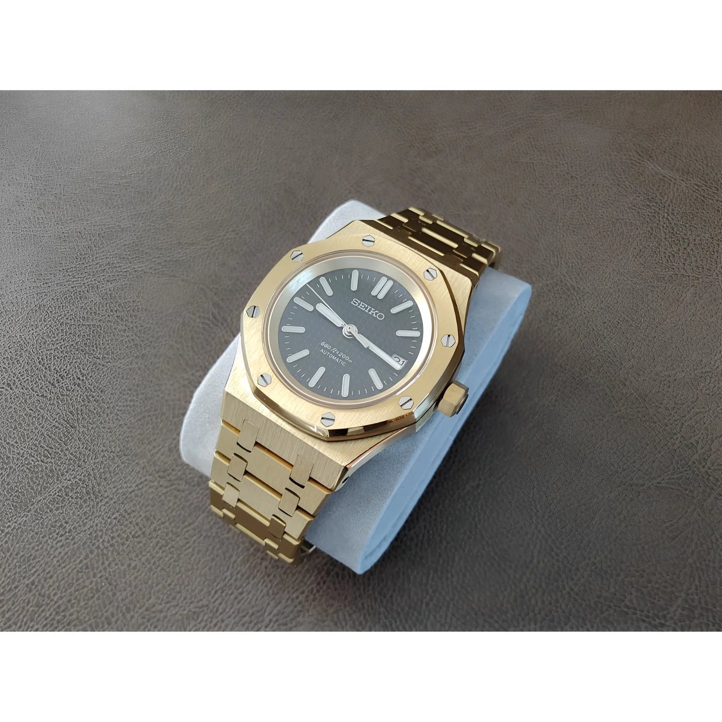 Gold stainless steel Royal Oak style watch with black dial and silver hour markers, 41mm case.