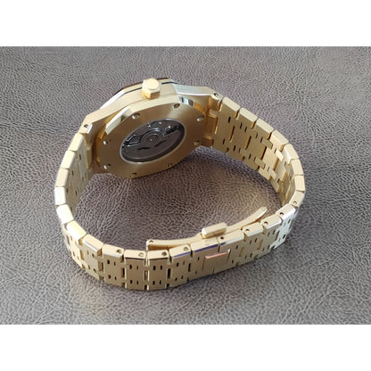 Gold stainless steel watch band with visible case back and black inner mechanism detail.
