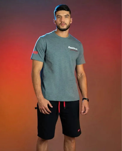 Gray FuelTech Anderson Dick Corvette C8 T-shirt worn with black shorts featuring red drawstrings.
