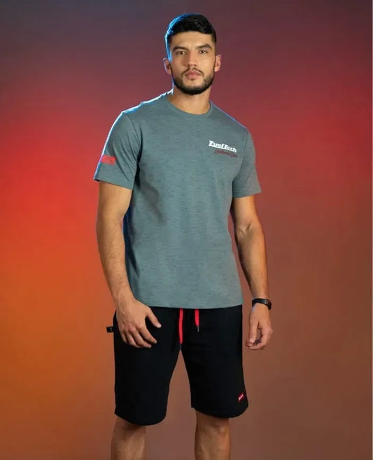 Gray FuelTech Anderson Dick Corvette C8 T-shirt worn with black shorts featuring red drawstrings.