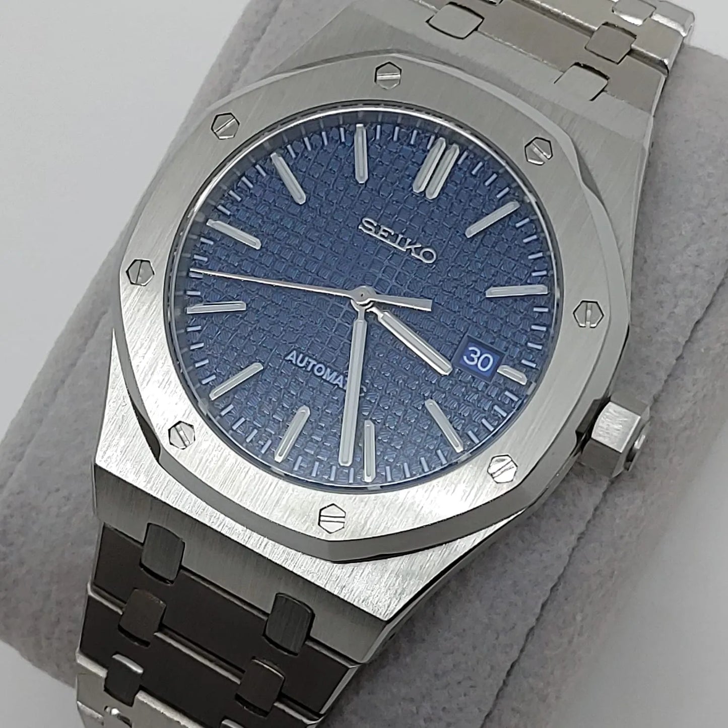 Seiko watch with 41mm navy blue textured dial, silver markers, date window, and stainless steel bracelet.