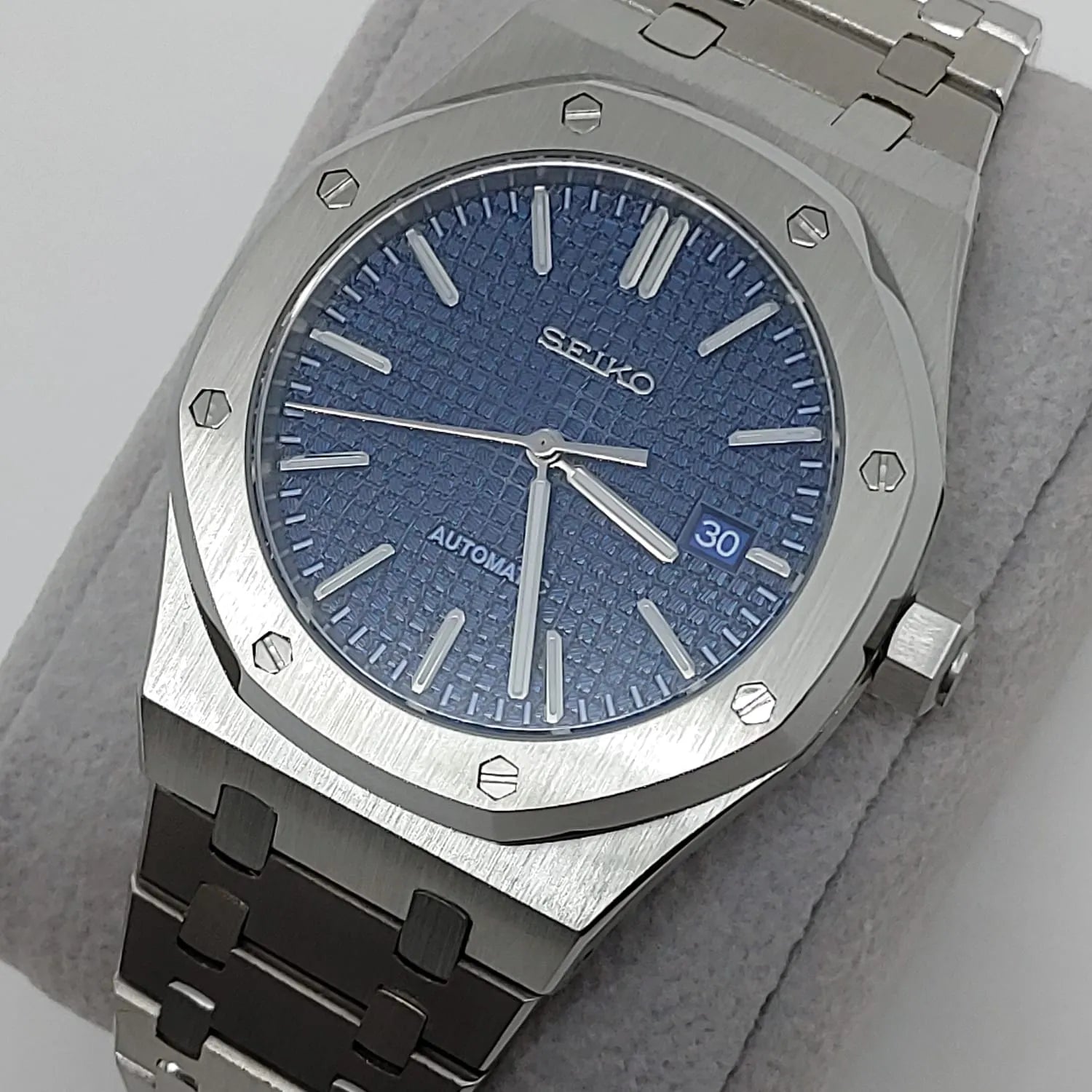 Seiko watch with 41mm navy blue textured dial, silver markers, date window, and stainless steel bracelet.