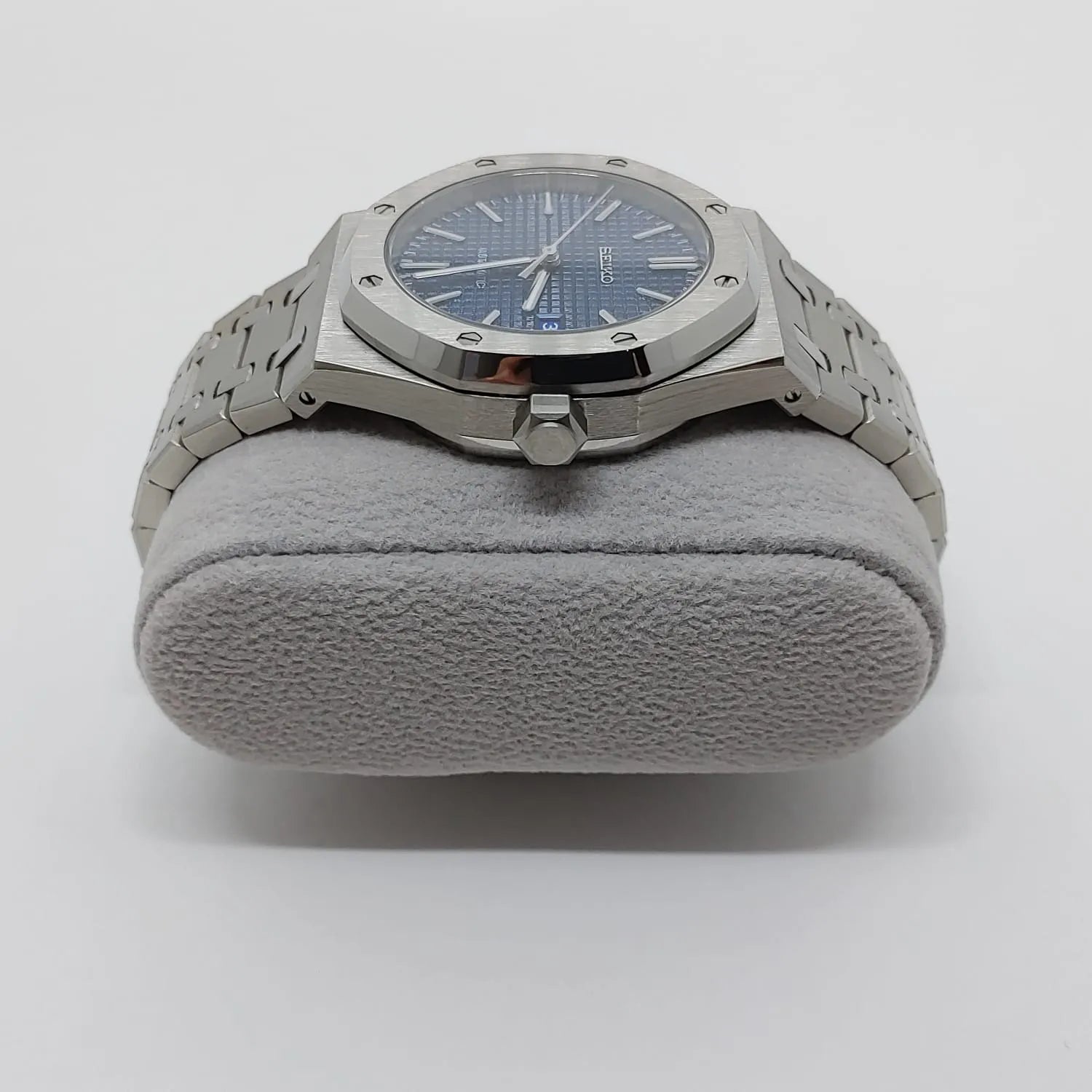 Silver stainless steel watch with octagonal bezel, navy blue dial, and silver bracelet.