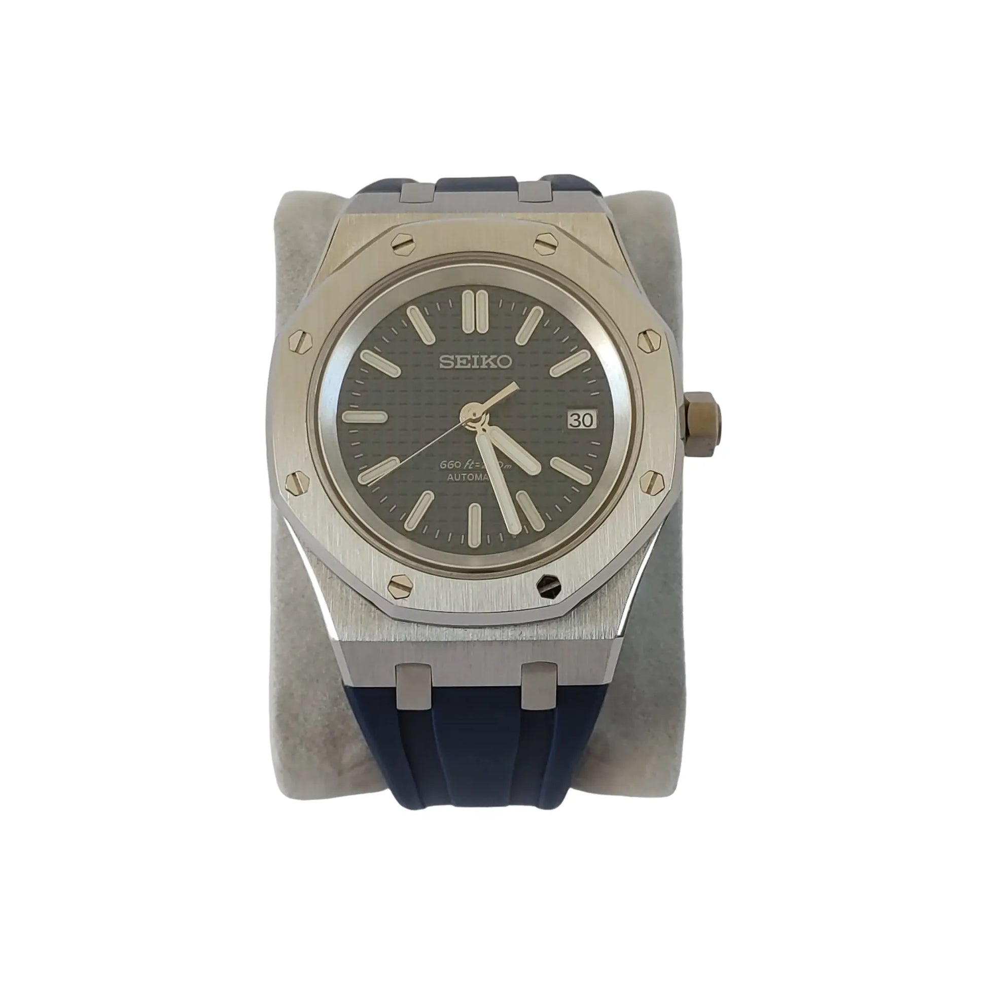 Seiko NH35 Royal Oak style watch with navy blue textured dial, silver case, and blue rubber strap.