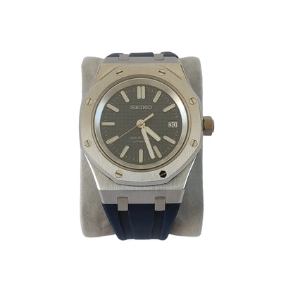 Seiko NH35 Royal Oak style watch with navy blue textured dial, silver case, and blue rubber strap.