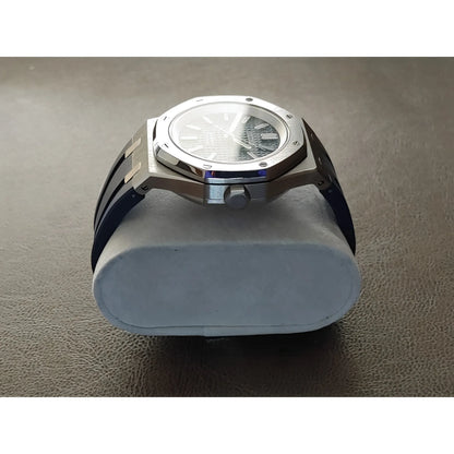 Seiko Royal Oak style watch with a 41mm silver stainless steel case, navy blue dial, and textured rubber strap.