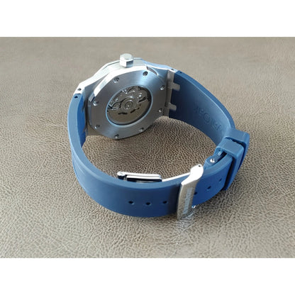 Seiko NH35 Royal Oak watch with navy blue rubber strap and silver buckle showing case back and crown.