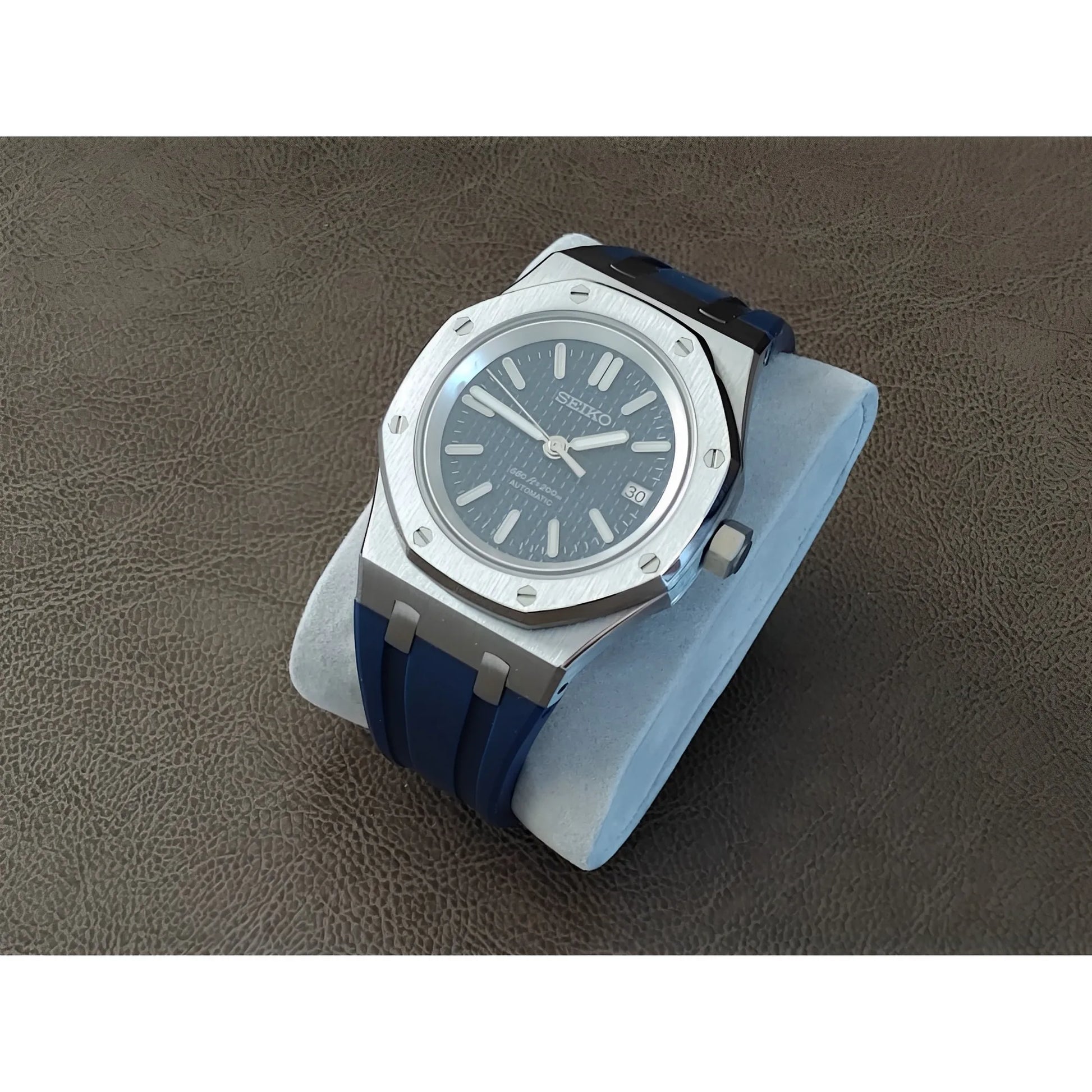 Seiko Royal Oak style watch with 41mm silver case, navy blue dial, and matching rubber strap.