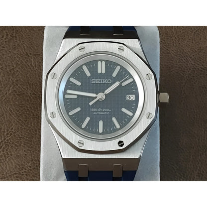 Seiko Royal Oak-style watch with a 41mm silver octagonal bezel, navy blue textured dial, white hour markers, and navy blue.