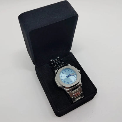 Seiko 40mm stainless steel watch with ice blue Arabic dial, day-date window, and metal bracelet in black presentation box.