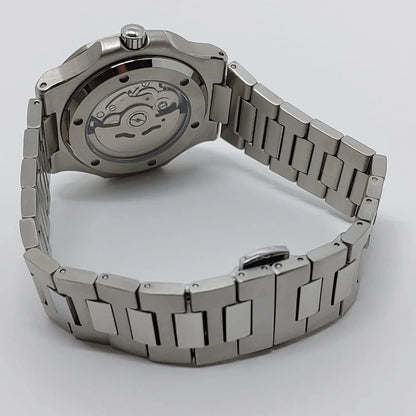 Stainless steel wristwatch with polished bracelet and transparent case back showing mechanical movement.
