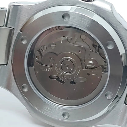 Close-up of stainless steel watch back revealing the automatic Seiko NH36 movement with visible gears and screws.
