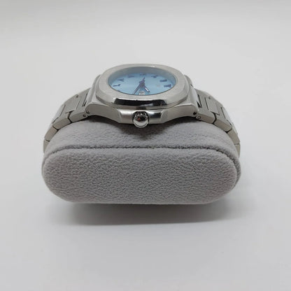 Silver stainless steel watch with round 40mm ice blue dial and Arabic numerals on gray cushion stand.