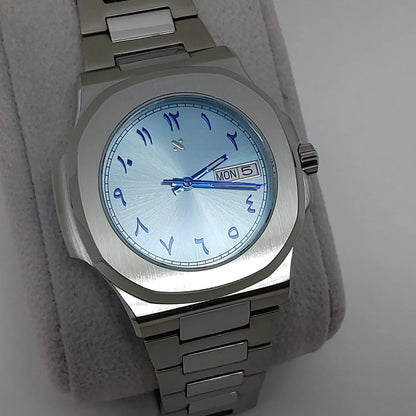 40mm stainless steel Nautilus watch with ice blue dial and blue Arabic numerals, day-date display, and matching blue hands.