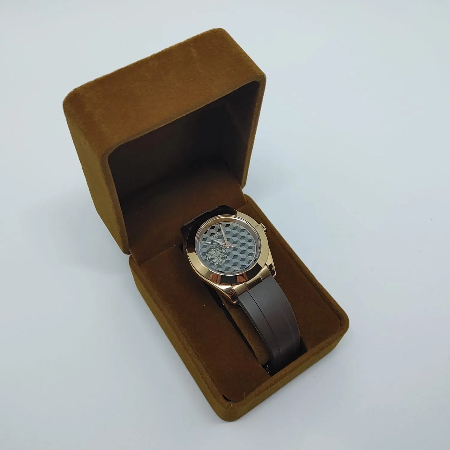 Seiko Hemicube watch with silver guilloche dial, rose gold case, and dark brown leather strap in brown velvet box.