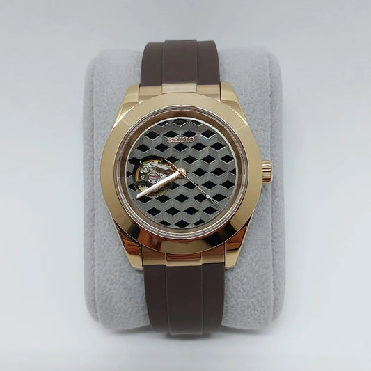 Rose gold-tone stainless steel watch with brown rubber strap and black guilloche patterned dial.