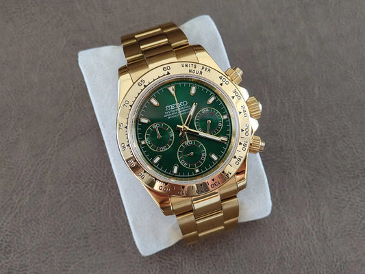 Gold stainless steel Seiko chronograph watch with green dial, three subdials, and tachymeter bezel.