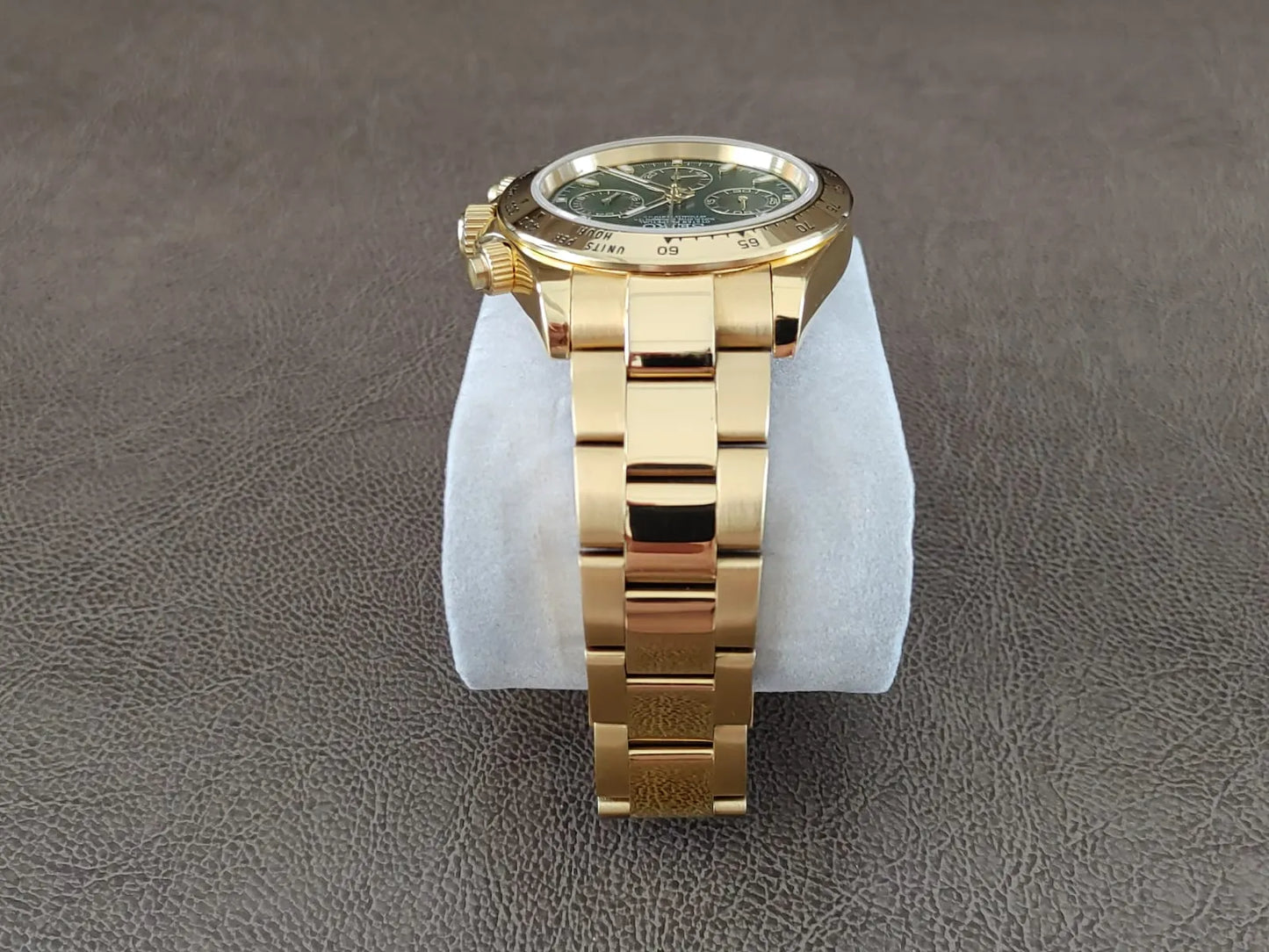 Gold stainless steel bracelet watch with green dial and gold accents, 40mm round case.
