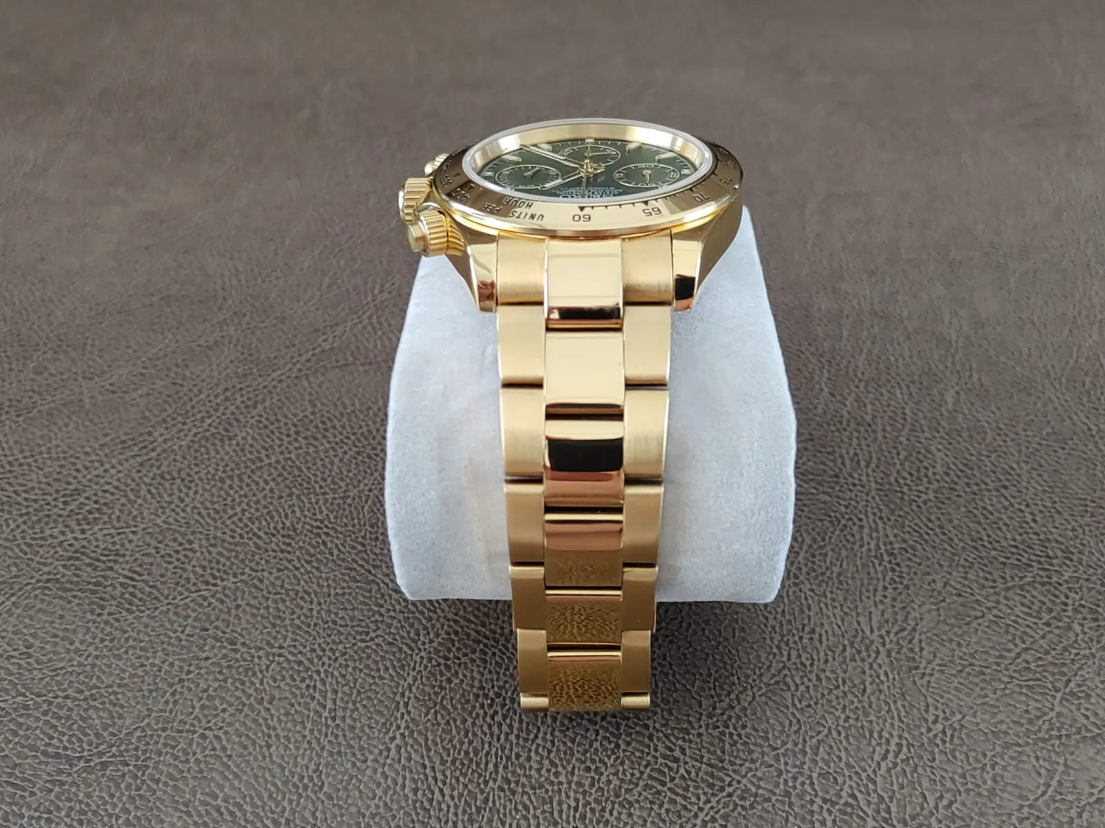 Gold stainless steel bracelet watch with green dial and gold accents, 40mm round case.
