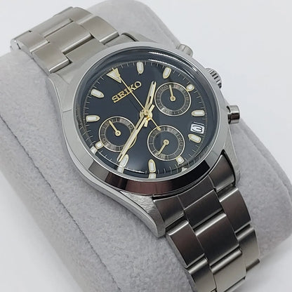 Seiko VK63 chronograph watch with black dial, gold-tone hands and markers, stainless steel case and bracelet, date window at