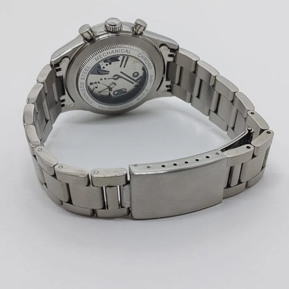 Seiko VK63 watch with stainless steel bracelet and open case back showing mechanical movement.