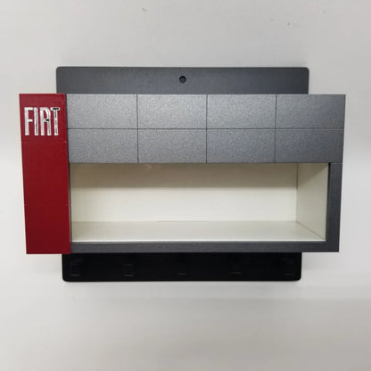 Black and gray Fiat wall key hook rack with red vertical panel and white interior shelf.