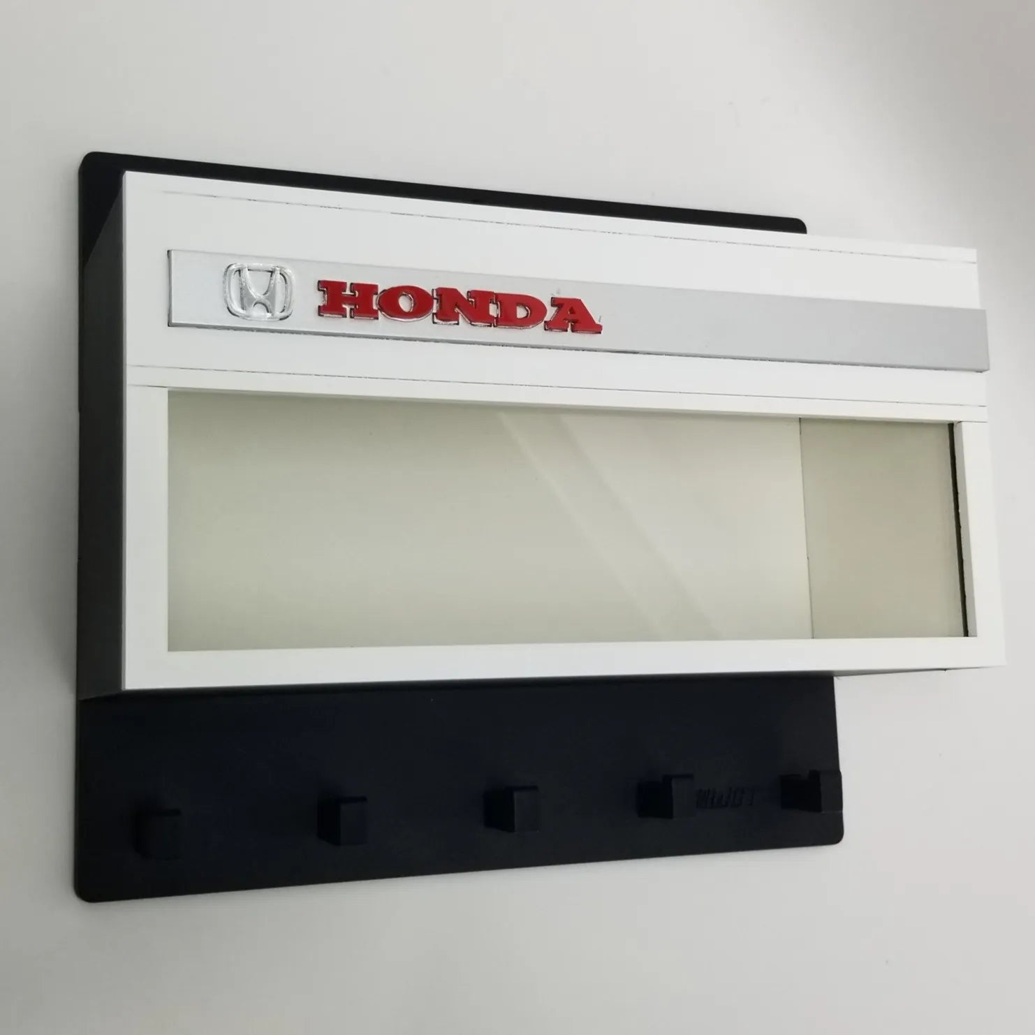 Honda Wall Key Hook Rack with red Honda logo, white display case, and five black hooks.