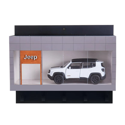 Miniature white Jeep SUV displayed inside gray wall-mounted case with Jeep sign and key hooks.