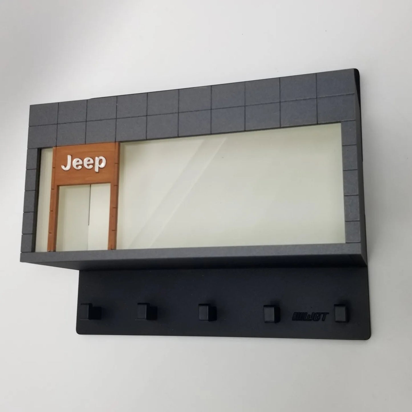 Black Jeep-themed wall key hook rack with five hooks and a display case resembling a building facade.