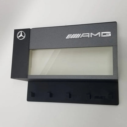 Black Mercedes AMG wall-mounted key hook rack with five hooks and display case window.