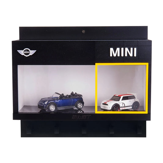Black wall-mounted display case with two scale model Mini cars, one blue convertible and one white hatchback with red roof.