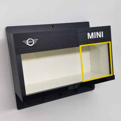 Black wall-mounted Mini key hook rack with display case and Mini logo detailing.
