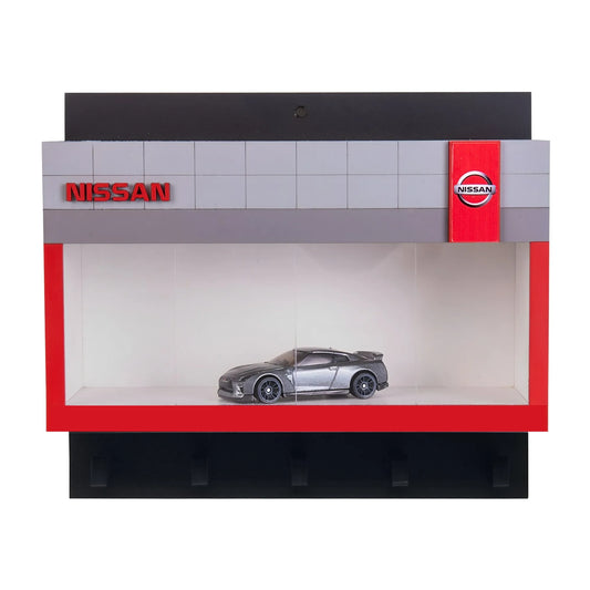 Black and red Nissan wall key hook rack featuring a silver scale model car in a display case.