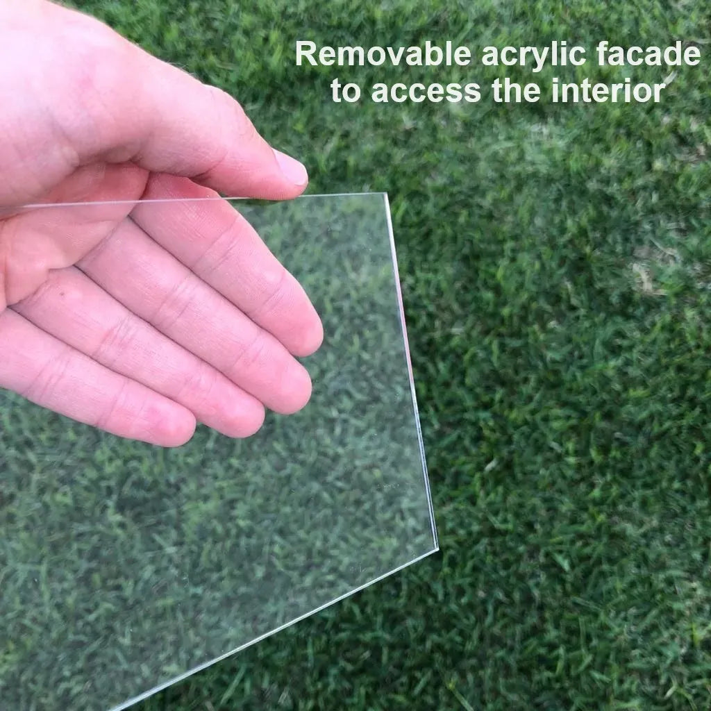 Clear acrylic removable facade for Scania wall key hook rack display case, held by hand against grass background.