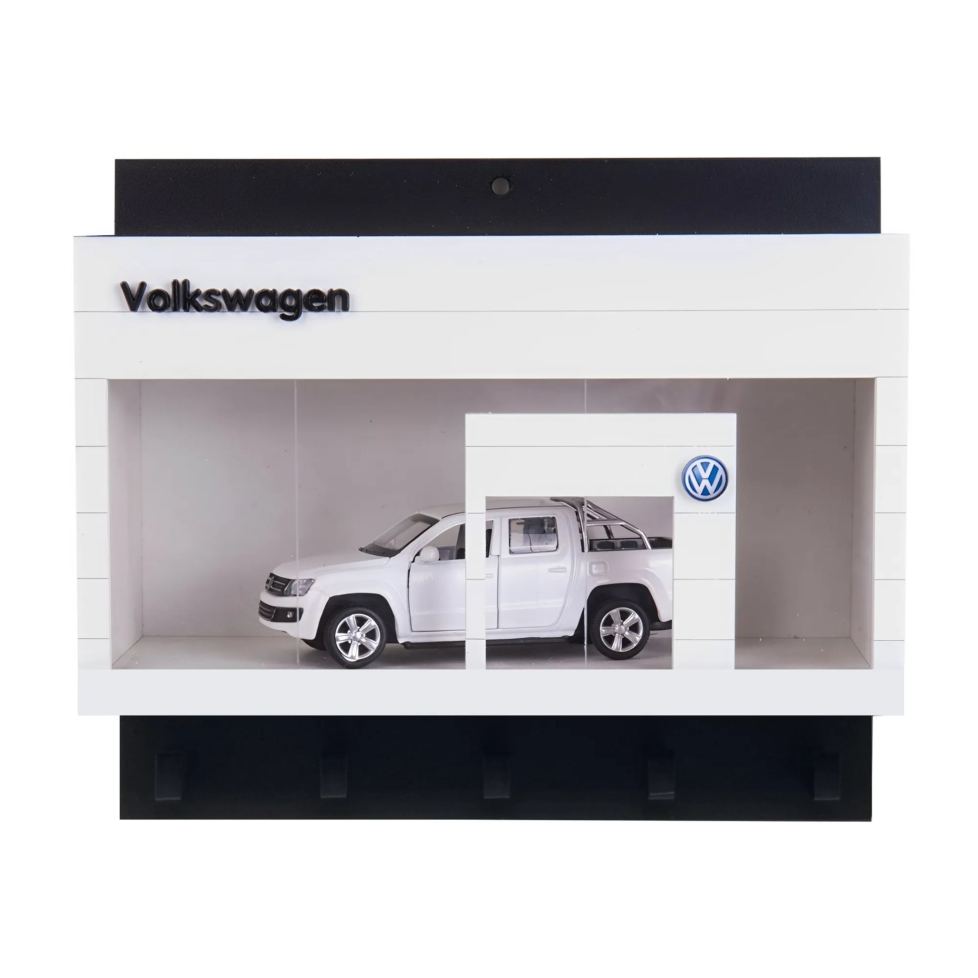 White Volkswagen wall key hook rack shaped like a miniature showroom with a silver scale model car inside.